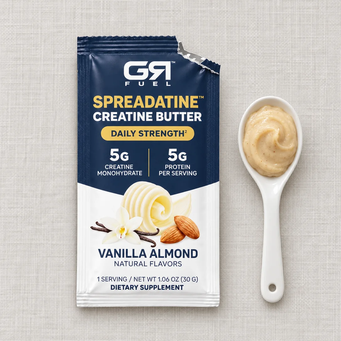 An open Spreadatine packet beside a spoonful of almond butter
