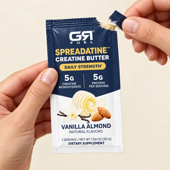 Two hands tearing the corner off a Spreadatine packet